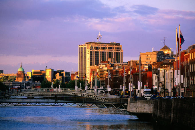 Evening falls over the city by the Liffey River.