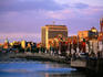 Evening falls over the city by the Liffey River.