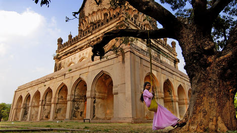 Girl on swing at tombs of Qutab Shahi kings.