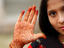 Girl with henna-painted hand, at tombs of Qutab Shahi kings.