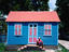 Man sitting on steps of Chattel House, Payne's Bay.