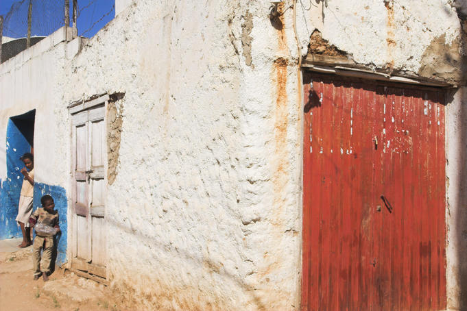 Children standing by house in old town.