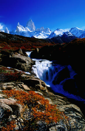 Monte Fitz Roy rises above a waterfall.