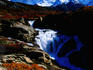 Monte Fitz Roy rises above a waterfall.