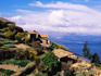 Thatched houses and garden plots above Lake Titicaca.