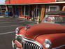 Red antique De Soto car in front of Discovery Antiques store.