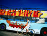 Female cyclist passing tourist bus, Langelinie.