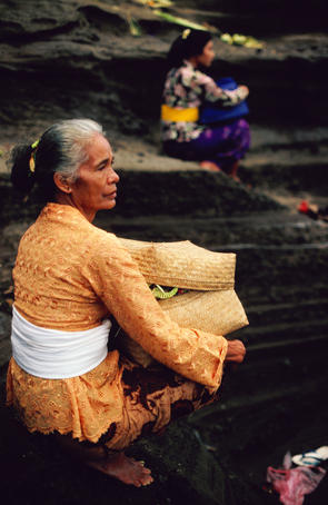 Seated women at Tanah Lot temple.