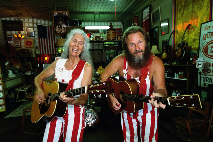 Musicians playing guitars inside Sandhills Curiosity Shop, Route 66.
