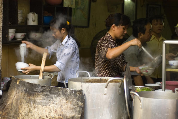 Serving up pho, noodle soup.