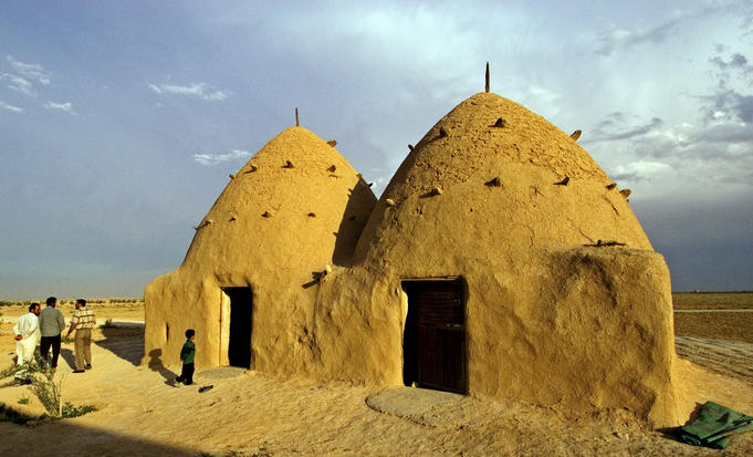 Conical mud-brick beehive houses, central Syria.