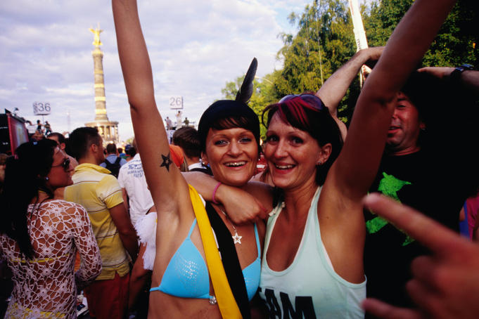 Two women enjoying the Berlin Love Parade in July.