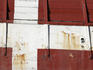 Red and white painted side of ship moored beside Nyhavn.