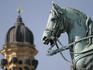 Equestrian statue and dome of Theatinerkirche or St Catejan, Odeonsplatz.