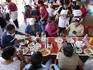 Outdoor restaurant patrons enjoying Sunday afternoon lunch (almuerzo) during religious festival in Tepic.