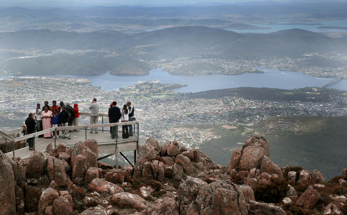 Tour group being photographed on top of Mount Wellington.