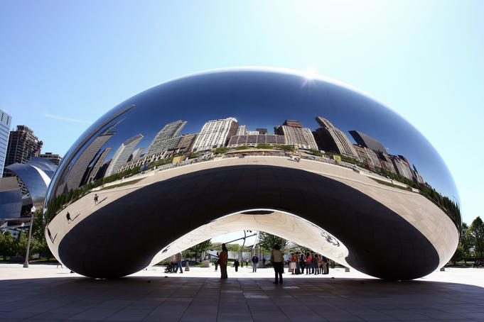 Cityscape reflected in the 'Bean' sculpture.