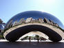 Cityscape reflected in the 'Bean' sculpture.