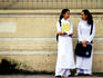 Schoolgirls talking in Ao Dai.