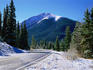 Snowfall on mountain and road.