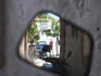 Street scene reflected in mirror of motor scooter, Patmos, Dodecanese Islands.