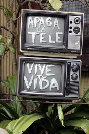 Television sculpture in someone's front garden, 'turn off the TV and live your life'.