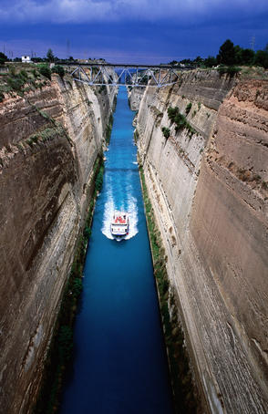 Boat cruising through Corinth Canal.