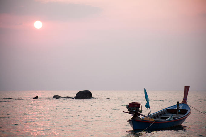 Longtail boat at sunset.