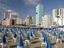 Furled beach umbrellas at Playa Popular, early morning.