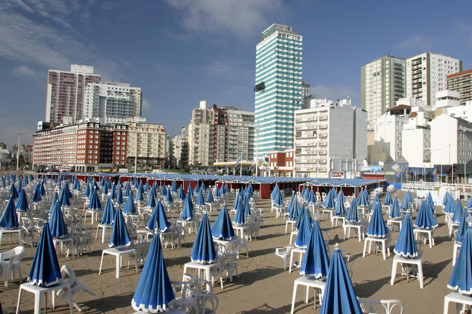 Furled beach umbrellas at Playa Popular, early morning.