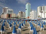 Furled beach umbrellas at Playa Popular, early morning.