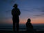 Man and woman watching the sunset, Zicatela beach.