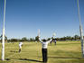 Umpire signals a goal at football match.