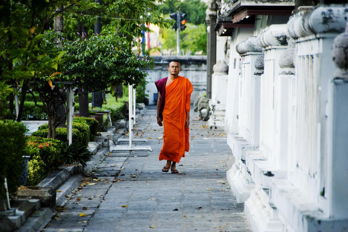 Monk walking on footpath.