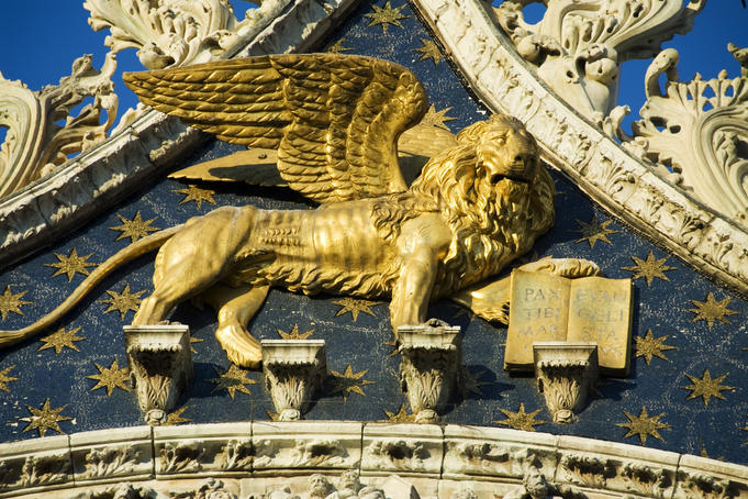 Winged lion of St Mark in facade of Basilica di San Marco.