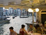 Alfresco diners on bank of Grand Canal near Rialto Bridge.