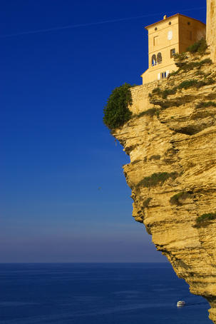 House hanging precariously on edge of cliff.
