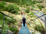 Hiker crossing Spasimata Bridge.