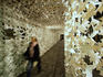 Girl walking through decorated tunnel.