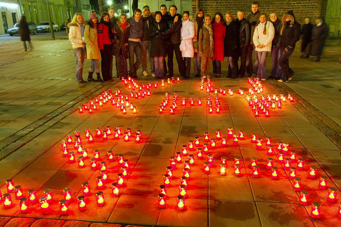 Crowd looking at candles commemorating All Soul's Day (Velines).