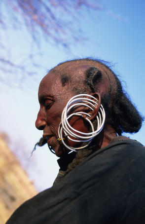 Portrait of woman of Wodaabe (aka Peul, Bororo, Fulani) tribe wearing earrings, near Agadez in Sahel region.