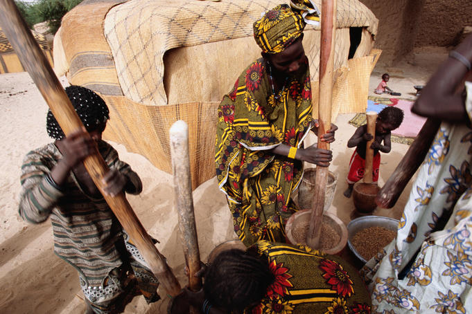 Songhai women pounding grain.