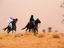 Songhai horsemen in sandstorm.