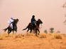Songhai horsemen in sandstorm.
