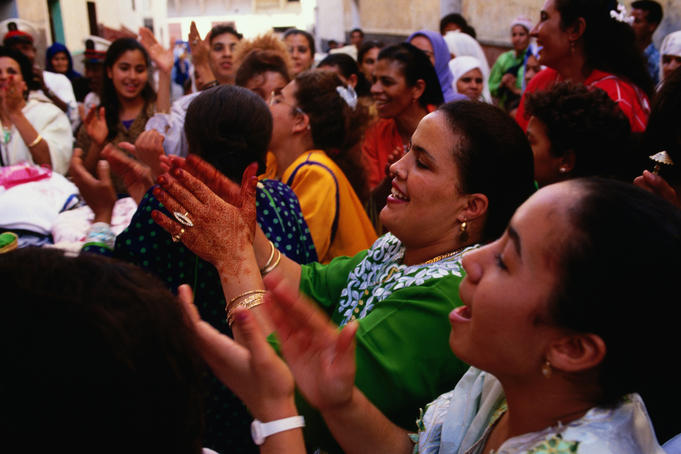 Women celebrating wedding in street.