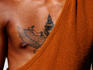 Man with tattooed chest.
