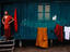 Monk and clothes line outside monastery building.