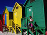Girl and bathing huts, Muizenberg Beach.