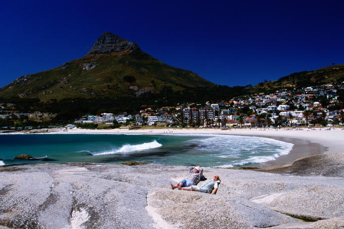 Sunbathers with Clifton Bay in background.