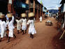 Women of a religious community carry baskets on their heads through the Soatanana village.